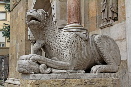 leone stiloforo con serpente; portale del Duomo di Fidenza photo