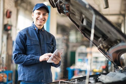 Mechanic using a tablet in his garage