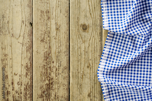 Blue folded tablecloth over wooden table