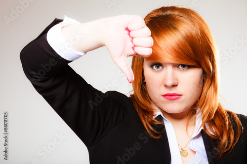 Unhappy woman giving thumb down gesture