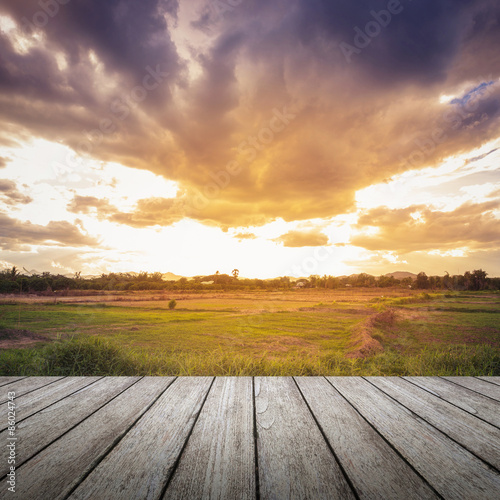 wood floor and field meadow with beautiful sunset