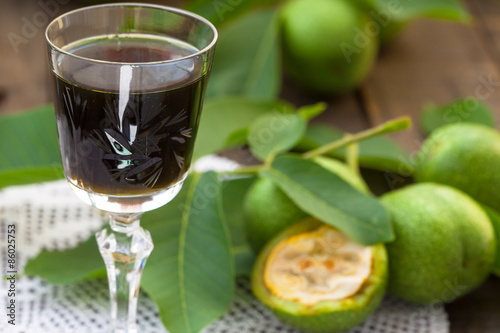 Glass of liquer from young green walnuts photo