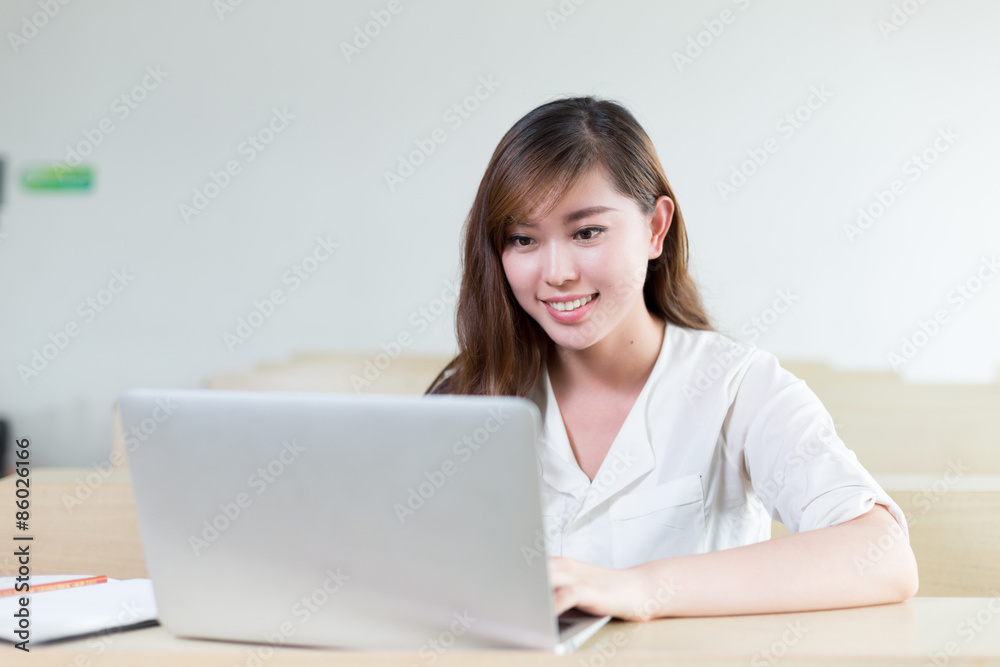 Asian beautiful female student study with laptop in classroom Asian beautiful female student study with laptop in classroom