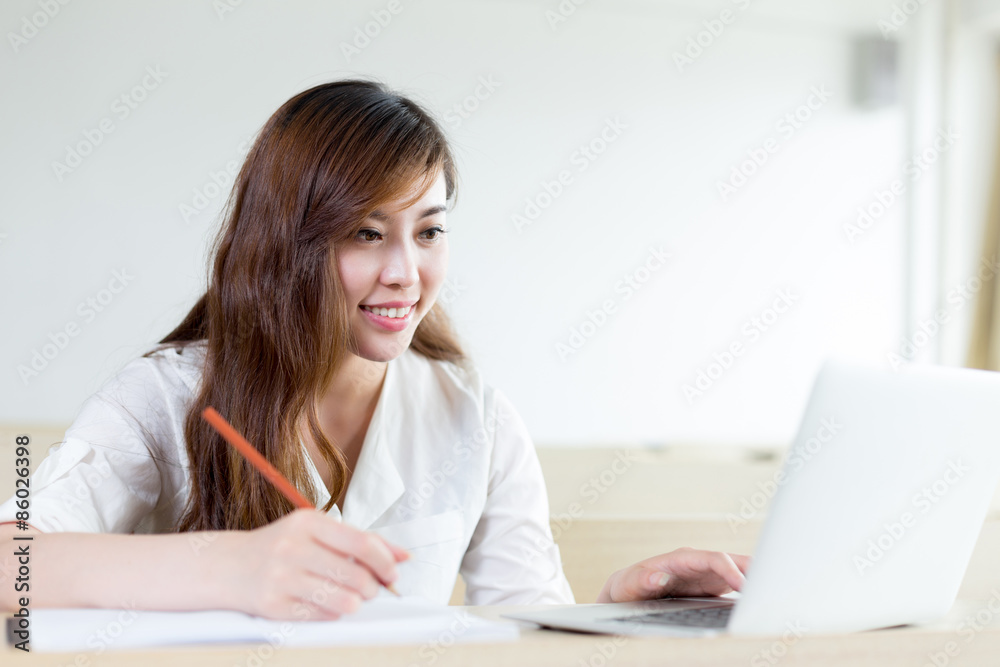 Asian  beautiful female student study with laptop in classroom