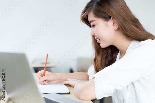Asian  beautiful female student study with laptop in classroom © zhu difeng