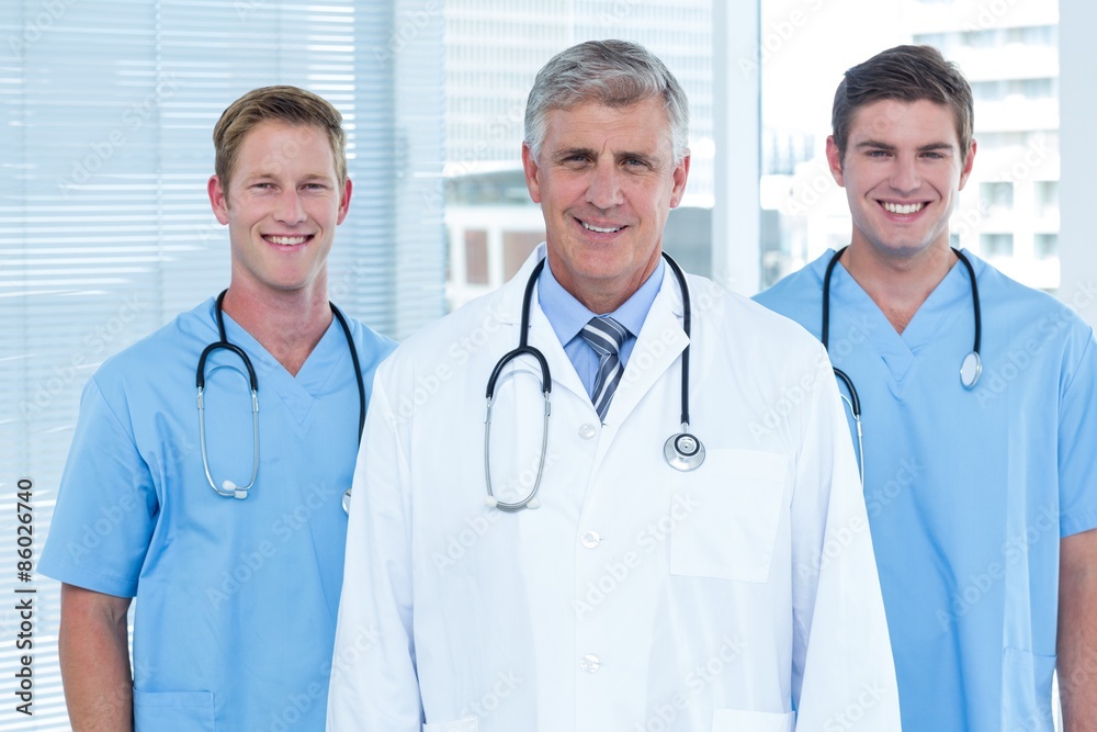 Team of doctors smiling at camera Team of doctors smiling at camera
