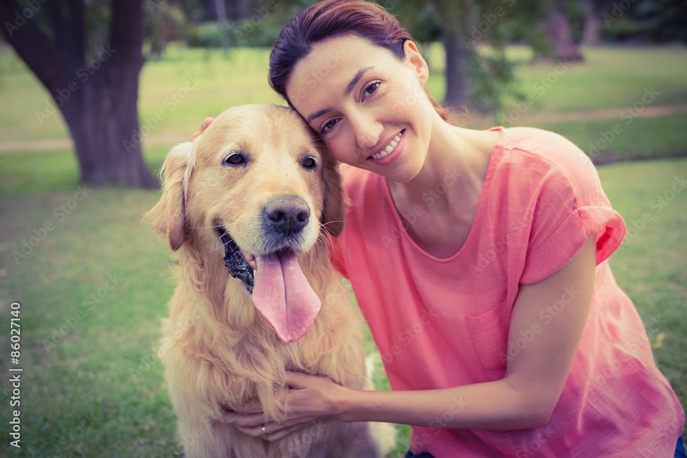 Pretty brunette looking at camera with her dog Pretty brunette looking at camera with her dog