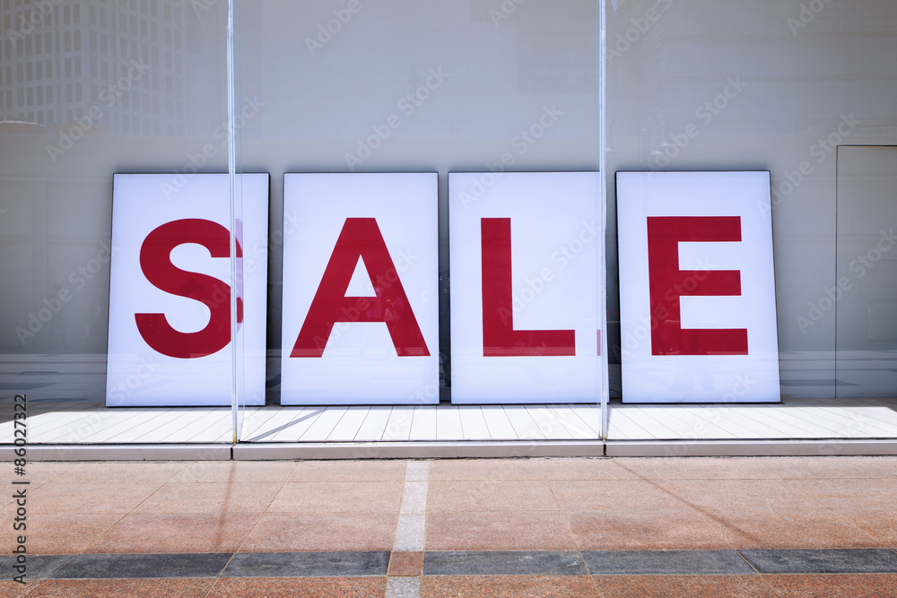 sale poster in shop display window sale poster in shop display window