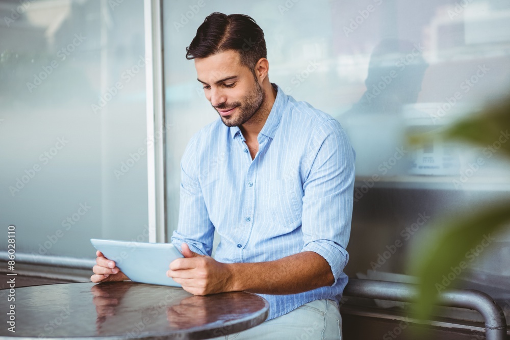 Smiling businessman using a tablet Smiling businessman using a tablet