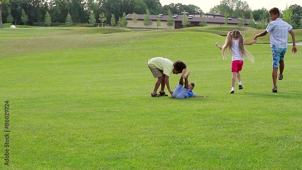 Four children are running and jumping on the lawn. Four children are running and jumping on the lawn.