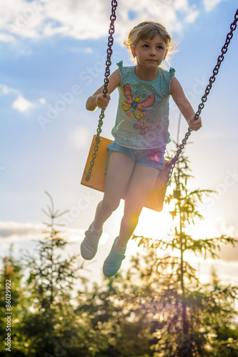 Girl riding on a swing © Ramil Gibadullin
