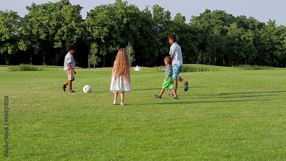Four kids are playing with a ball on evening glade. Four kids are playing with a ball on evening glade.