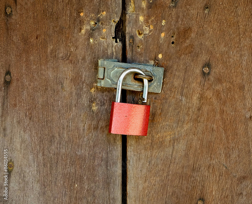 lock hanging on padlock with wooden background