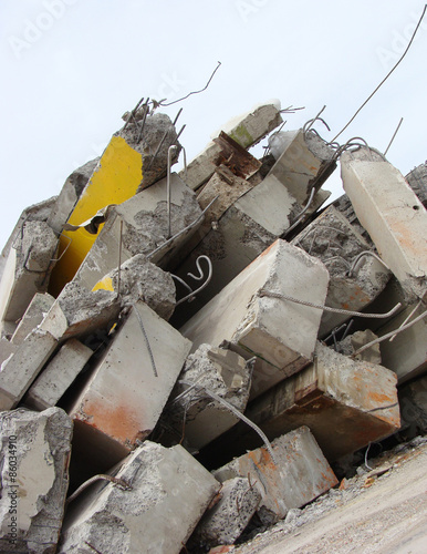 large concrete chunks with twisted metal on a demolition site