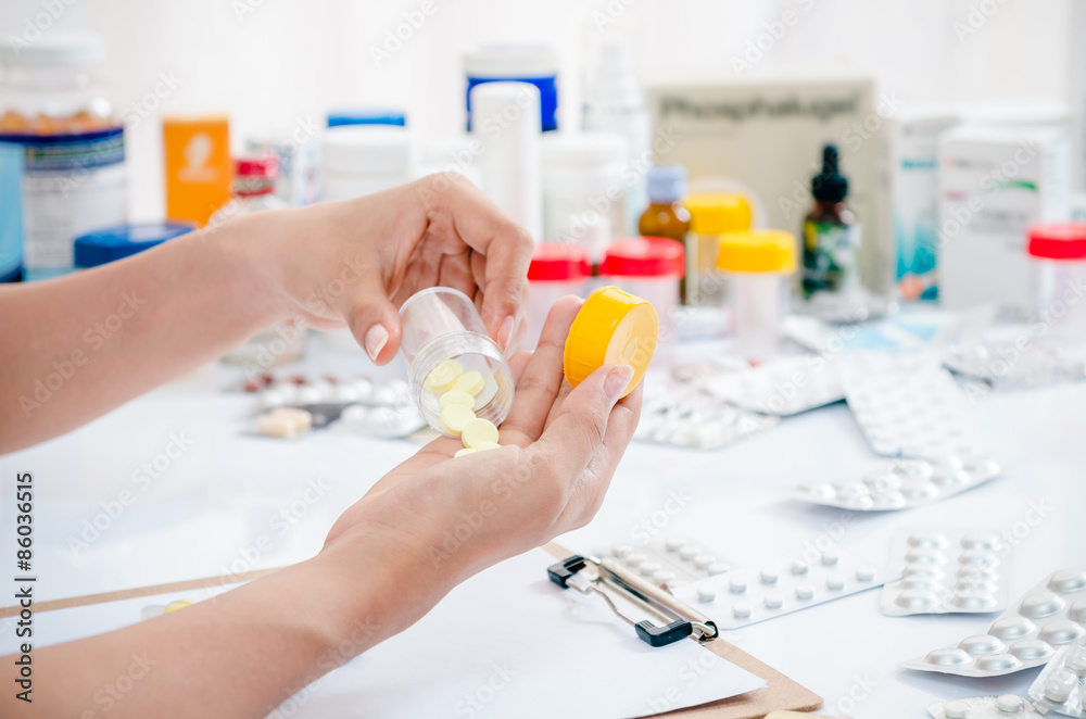 pharmacist handling medicine in a clear container
pharmacist handling medicine in a clear container