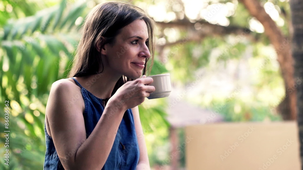 Young woman relaxing and drinking coffee while standing on terrace
Young woman relaxing and drinking coffee while standing on terrace