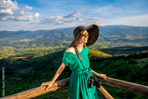 Woman on wooden terrace in the mountains