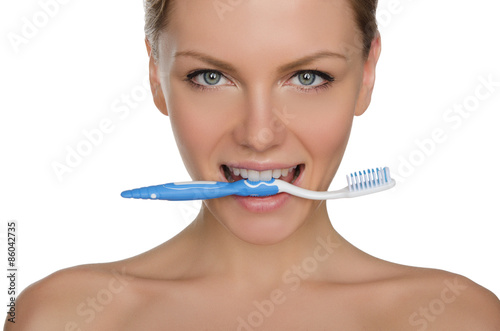Portrait happy woman with toothbrush in teeth
