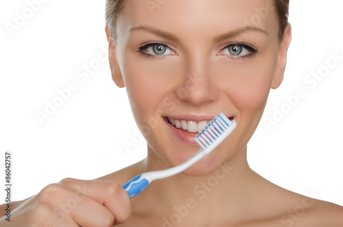 young woman with toothbrush in mouth