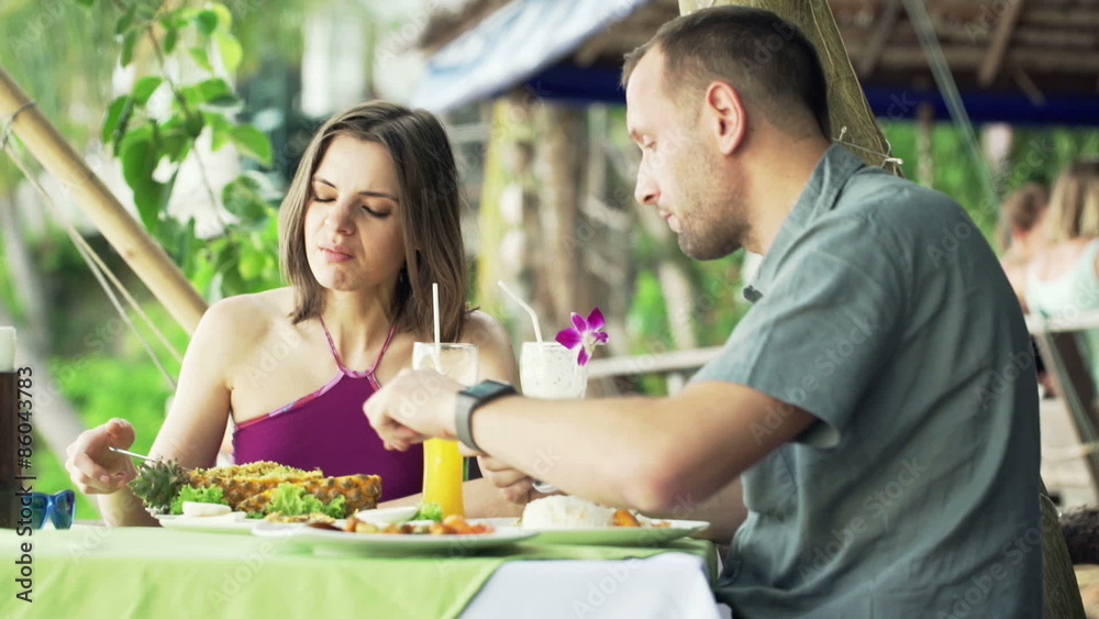 Young couple eating and fighting in exotic cafe
Young couple eating and fighting in exotic cafe