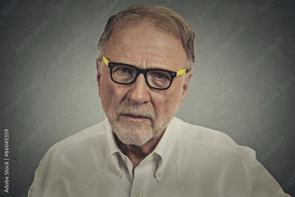 senior elderly skeptical man with eyeglasses