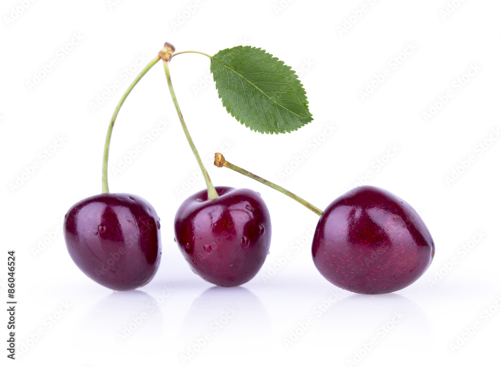 Three ripe cherries with leaves on a white background Three ripe cherries with leaves on a white background