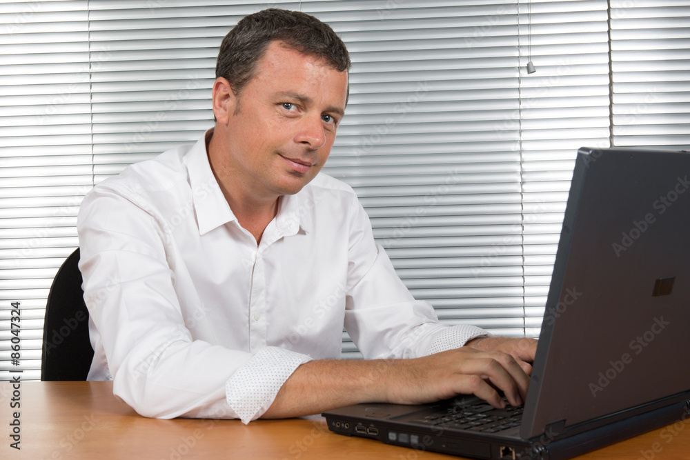 Charming and handsome Business man at his office Charming and handsome Business man at his office