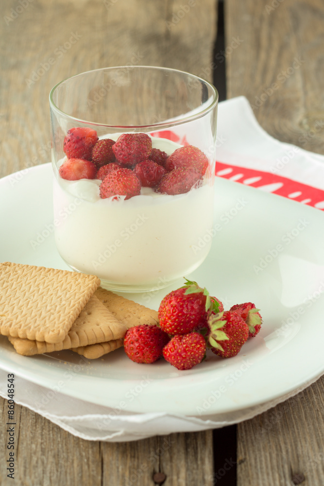 Cream pudding with strawberry in glass and crackers Cream pudding with strawberry in glass and crackers