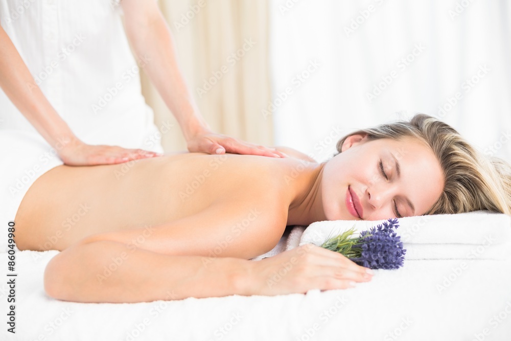 Obraz premium Beautiful blonde lying on massage table with lavanda
