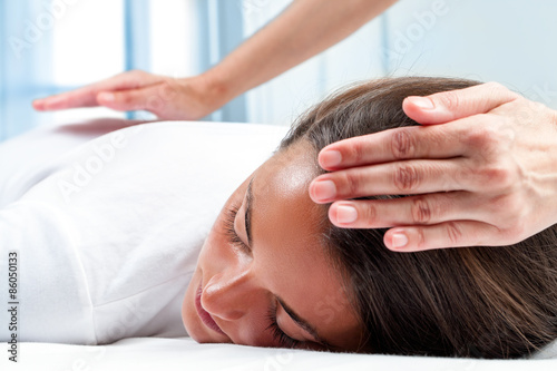 Therapists hands doing reiki therapy on girl. photo