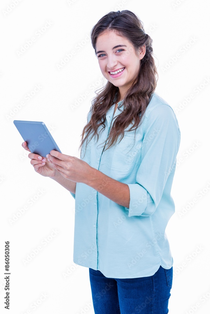 Pretty hipster smiling at camera and holding tablet Pretty hipster smiling at camera and holding tablet