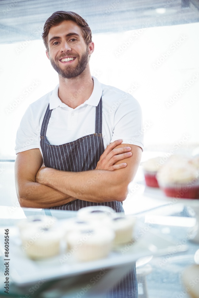 Smiling worker posing behind the counter Smiling worker posing behind the counter