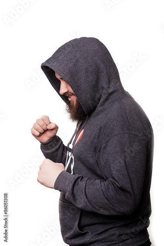 Boxer with a serious face with a beard in the hood in training. Isolated on white background.