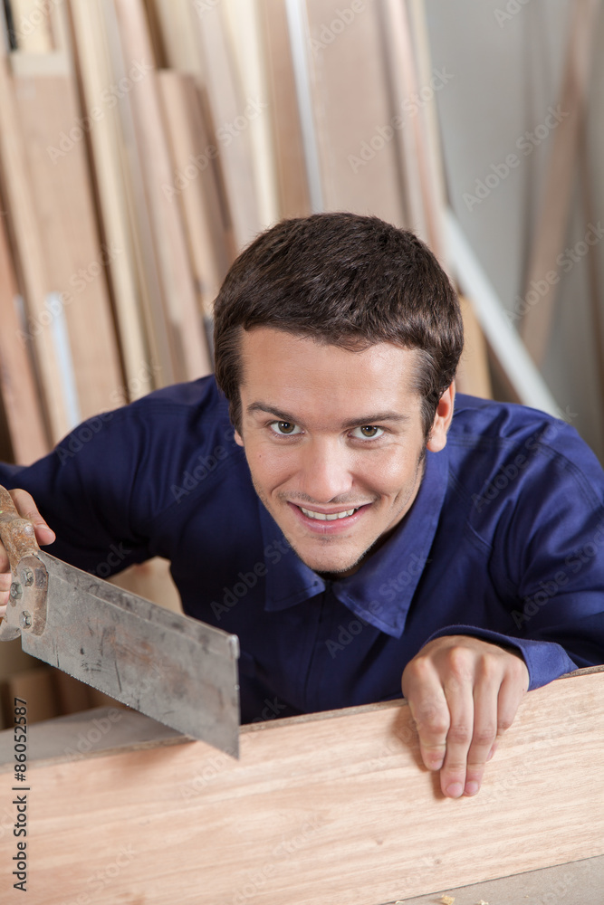 Happy guy using a saw Happy guy using a saw