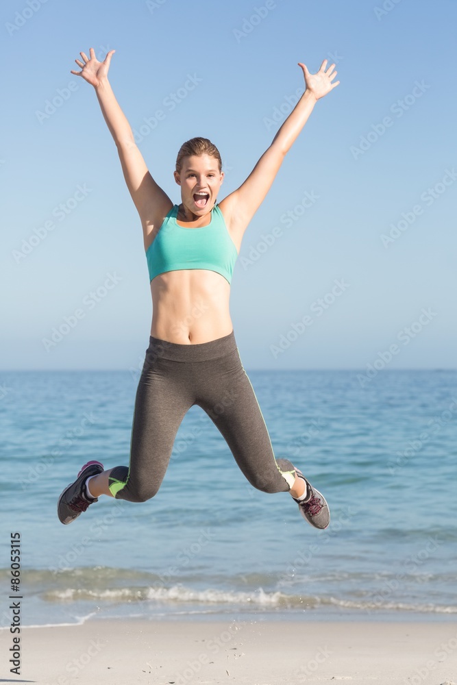 Beautiful fit woman cheering in front of sea Beautiful fit woman cheering in front of sea