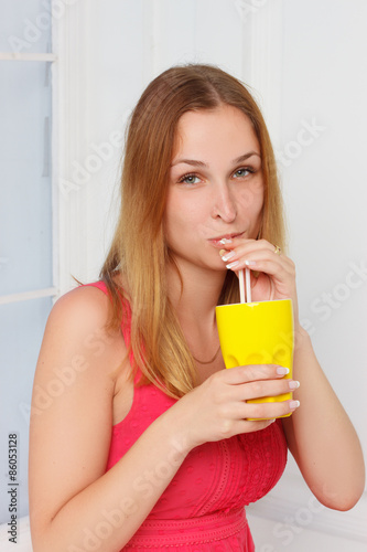 girl in a pink dress with yellow glass hand at home 