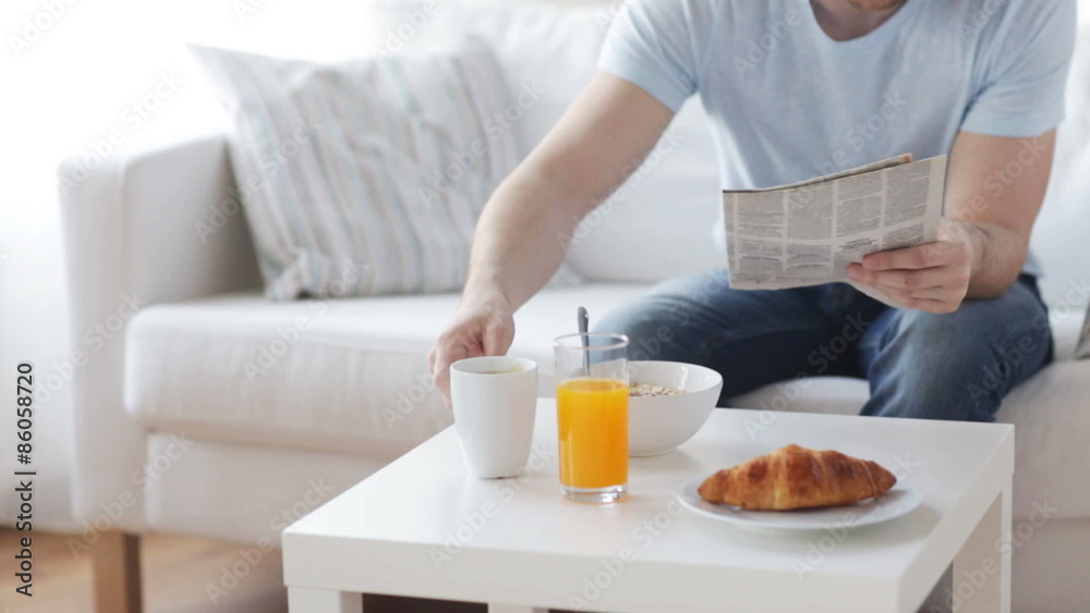 close up of man with newspaper having breakfast close up of man with newspaper having breakfast