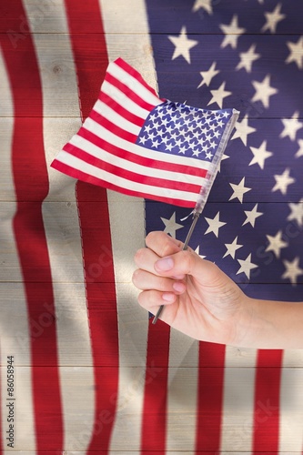 Fototapeta Naklejka Na Ścianę i Meble -  Composite image of hand waving american flag