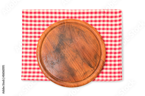 Round wooden board with checked tablecloth isolated on white background
