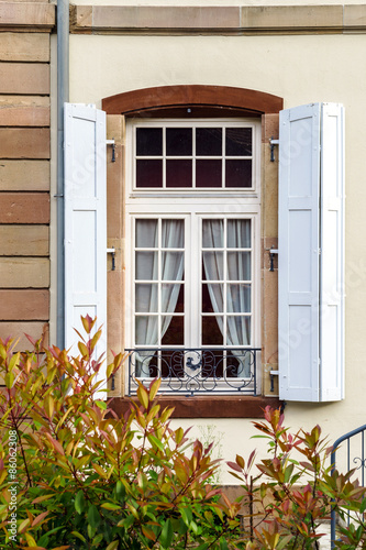 Big pvc window with decoration elements in old french house