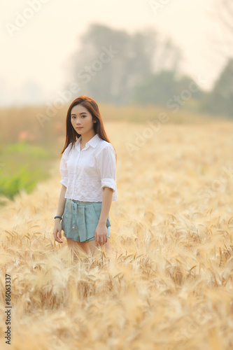 Asian girl on wheat field