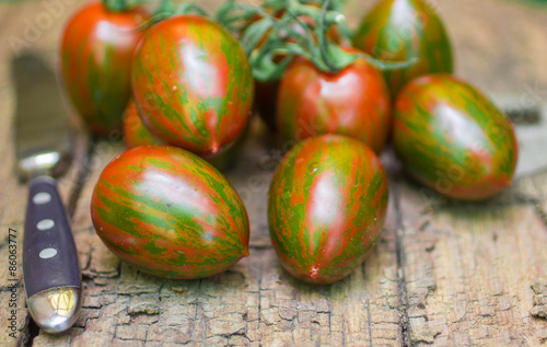 Tiger striped tomatoes on an old wooden table