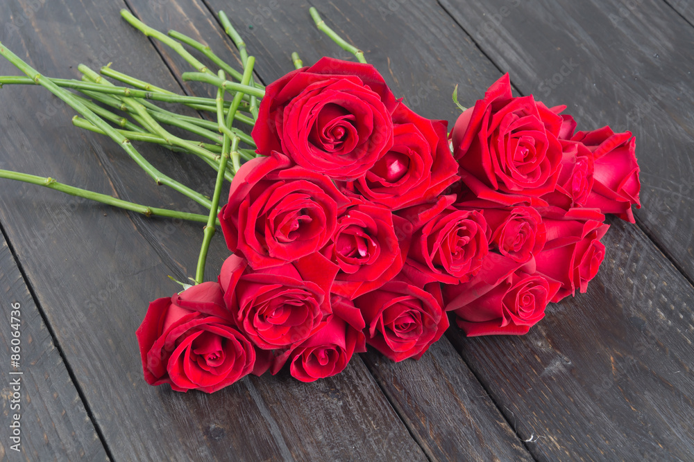 red rose bouquet on wood background red rose bouquet on wood background
