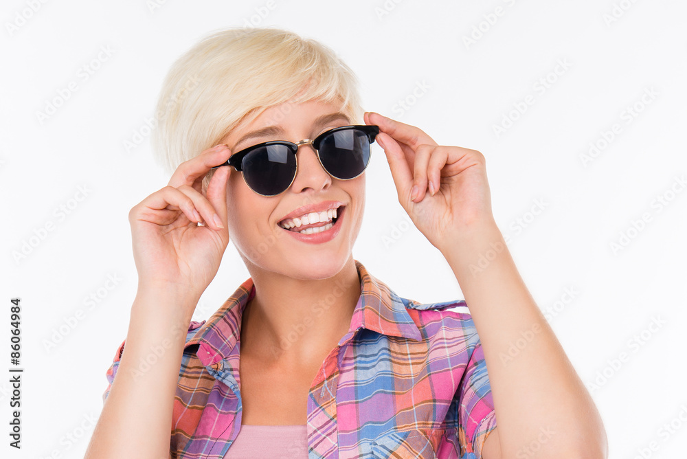 Cheerful girl adjusting her glasses and smiling Cheerful girl adjusting her glasses and smiling