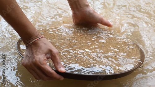 Gold pan with golden nuggets 
