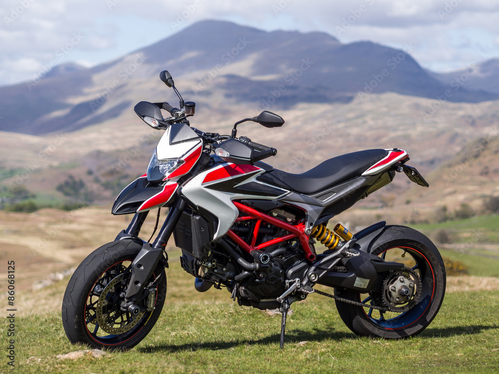 Fototapeta premium A supermotard type motorcycle with cloud in its background