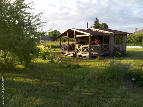 Small wooden bungalow with a terrace outdoors