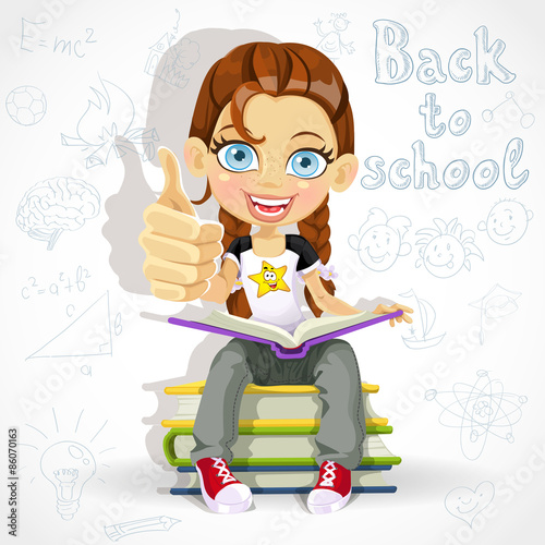 Joyful schoolgirl reading a book while sitting on a pile of book