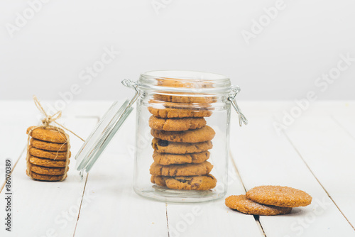 Obraz na plátne Cookies in the jar on the white wooden table.