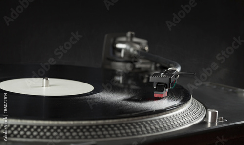 Turntable playing vinyl close up with needle on the record